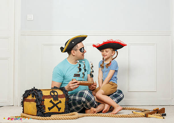 istock Father and his daughter dressed as pirates sharing a fun moment 2243024596
