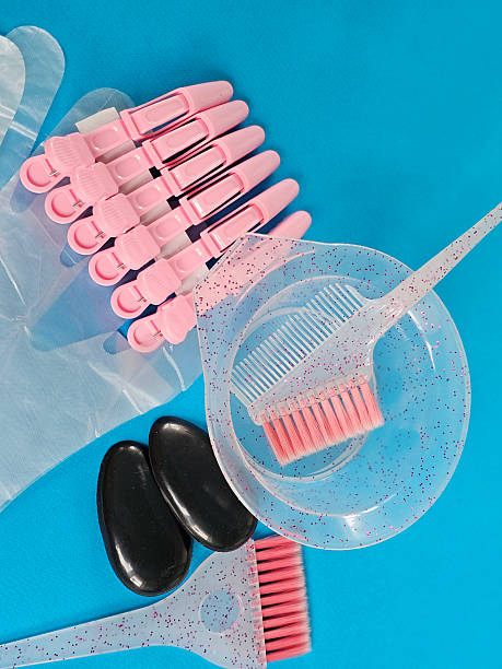 istock Coloring supplies arranged on a blue backdrop for a hair transformation project 2243026773