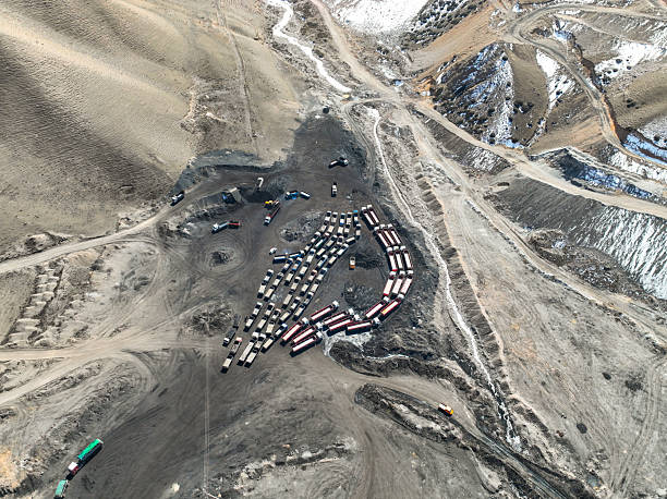 istock Top-down view of trucks and trailers parked at a remote coal loading site 2243028284