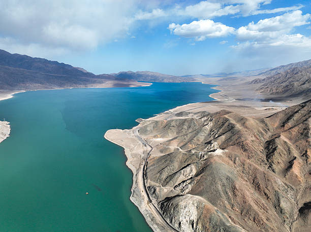istock Wide turquoise lake in an arid valley bordered by rugged mountains 2243028369