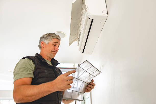 istock Professional repairman installing air conditioner in a room 2243028628