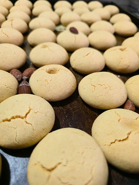istock Freshly baked nankhatai cookies with almonds arranged on baking tray 2243028689