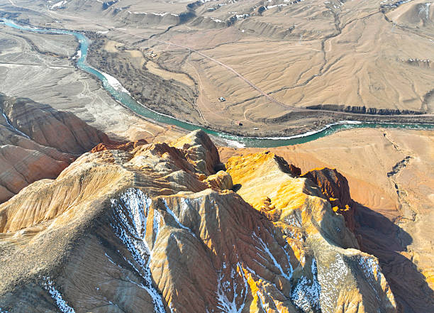 istock Colorful eroded mountains towering over a winding turquoise river 2243029513