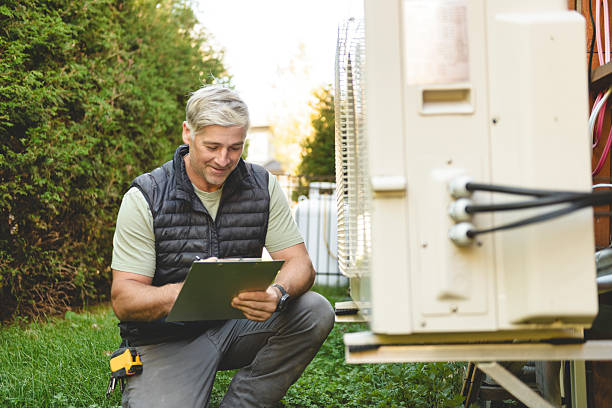 istock Technician working on air conditioning or heat pump outdoor unit 2243029595
