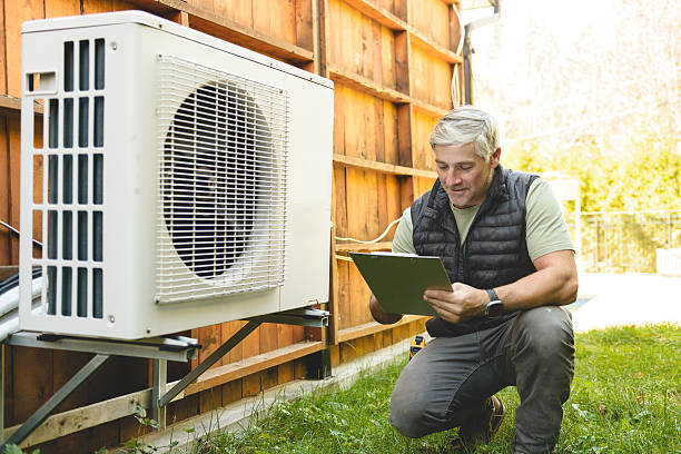istock Technician working on air conditioning or heat pump outdoor unit 2243029597