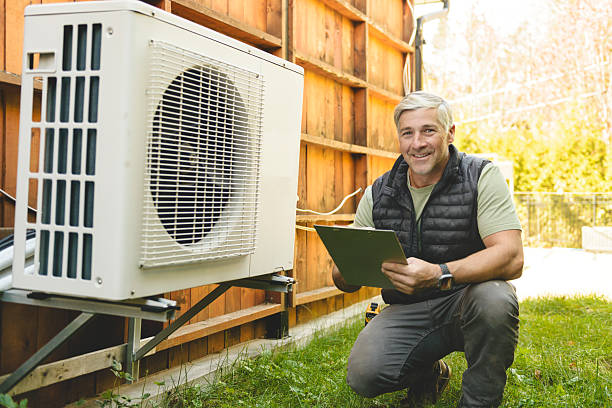 istock Technician working on air conditioning or heat pump outdoor unit 2243029613