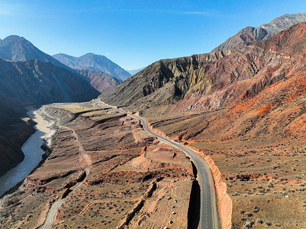istock Curved highway following a river through colorful red and brown mountains 2243029871