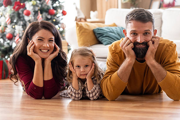 istock Family Posing by Christmas Tree 2243030031