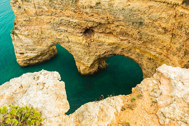 istock Explore heart-shaped natural arches under rugged cliffs at Praia da Marinha in Algarve Portugal 2243030492