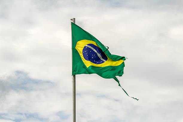 istock Torn, worn-out Brazilian flag fluttering. 2243032991