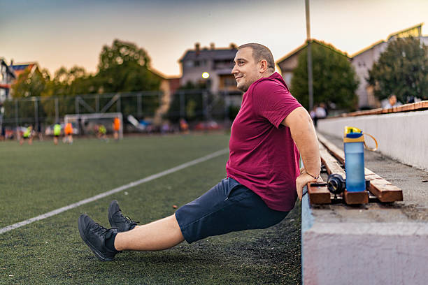 istock Overweight men doing exercises outdoor. 2243034112