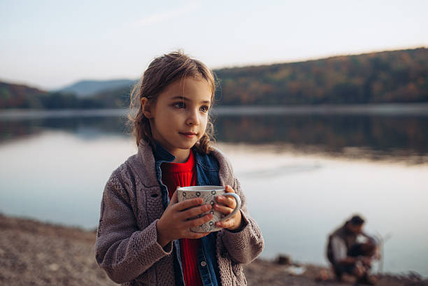 Girl in autumn nature drinking hot tea.. Indian summer concept.