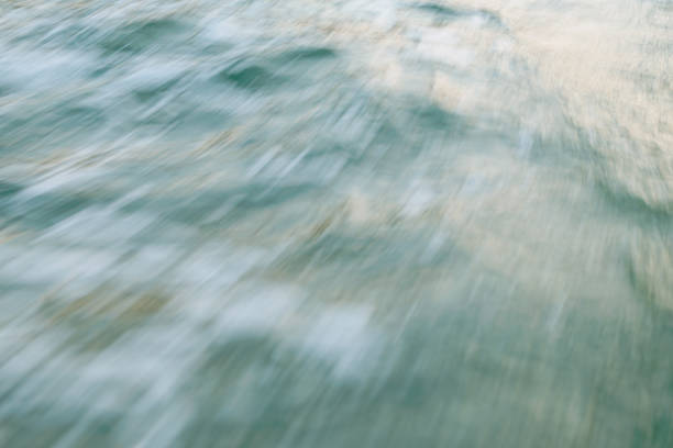 Calm ocean water surface with gentle ripples and bubbles