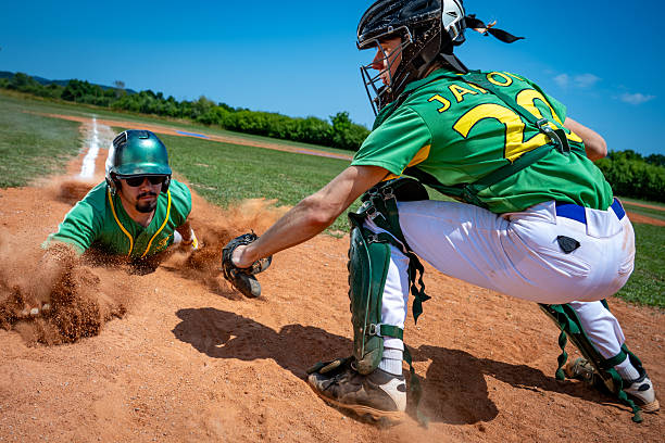 istock Medium Shot Playful Baseball Action at Home Plate 2243046563