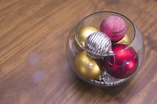 istock a clear, wavy-edged glass vase filled with Christmas ornaments a 2243049036