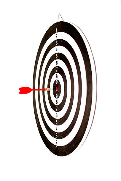 A well-aimed dart strikes the bullseye on a black and white dartboard target