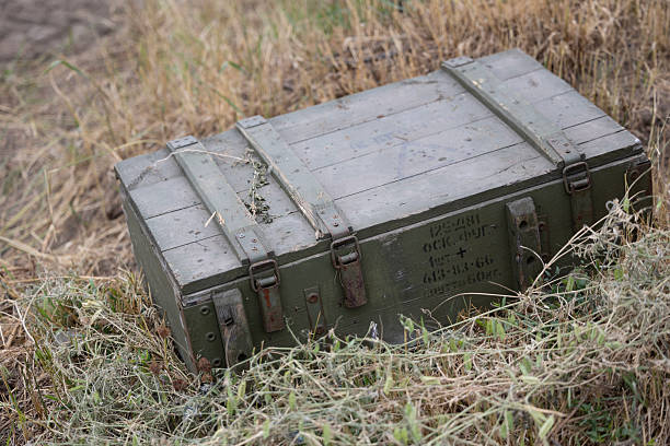 An old, green wooden crate for a 125mm high-explosive tank shell, used for the Soviet D-81TM (2A46) cannon. Left behind on a battlefield, this discarded container is a stark artifact of recent combat.