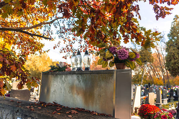 istock Grave with flowers and candles on All Saints’ Day 2243059611