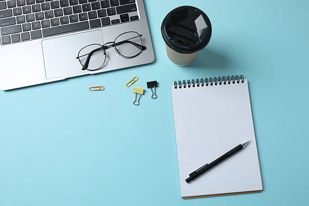 istock laptop glasses coffee headphones notepad on a blue background with space for text 2243062428