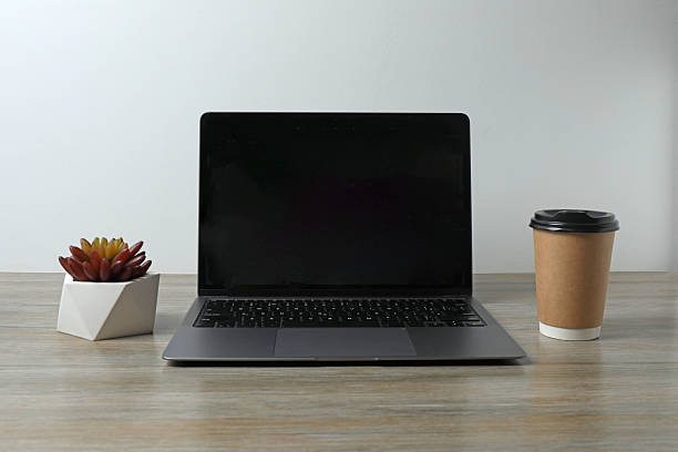 istock laptop coffee notepad on wooden background with space for text 2243062548