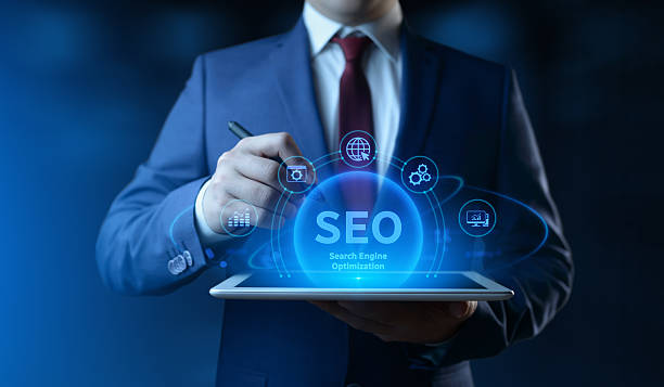 istock Businessman holding tablet with Search Engine Optimization SEO icons on screen - Digital Marketing Concept 2243064575