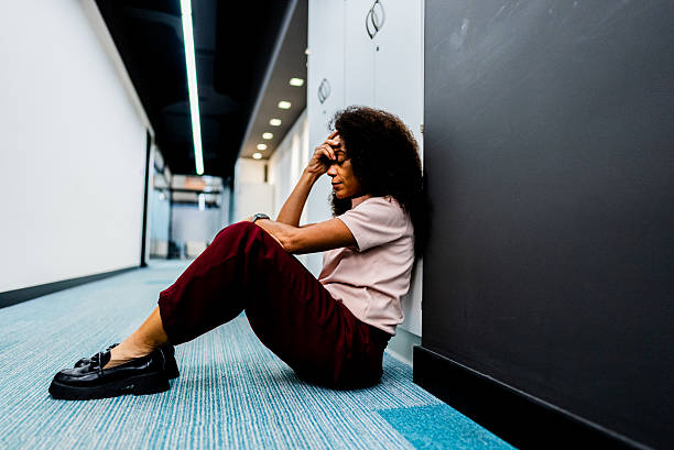 istock Stressed businesswoman sitting on office floor looking overwhelmed 2243065774