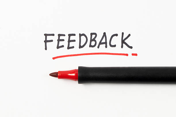 Hand writing Feedback with black marker and underline with red marker isolated on white background