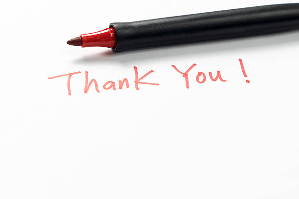 istock Hand written thank you message with a red pen on white background, gratitude concept. 2243080353