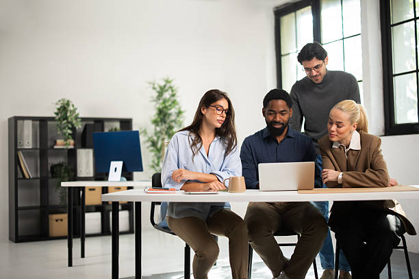 istock Diverse business team collaborating using laptop in office 2243082819