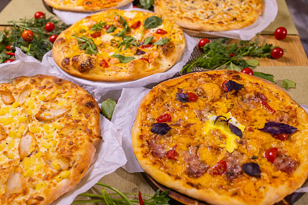 istock Varied pizzas with sauce. On a wooden table. 2243084342