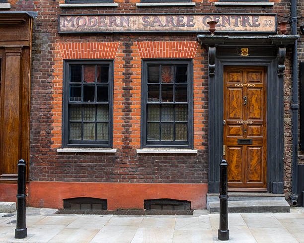London, UK - July 29th 2025: The ghost sign on the exterior of a building which was once home to the Modern Saree Centre, located on Princelet Street in London, UK.
