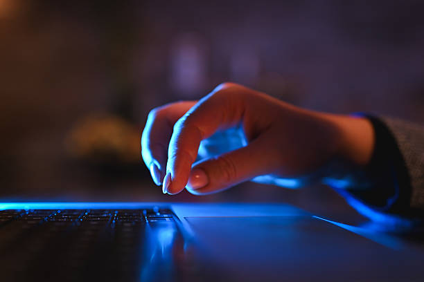 istock Close up hand typing on laptop keyboard at night 2243084621