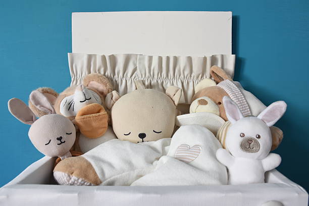cute stuffed animals stored in a wooden box