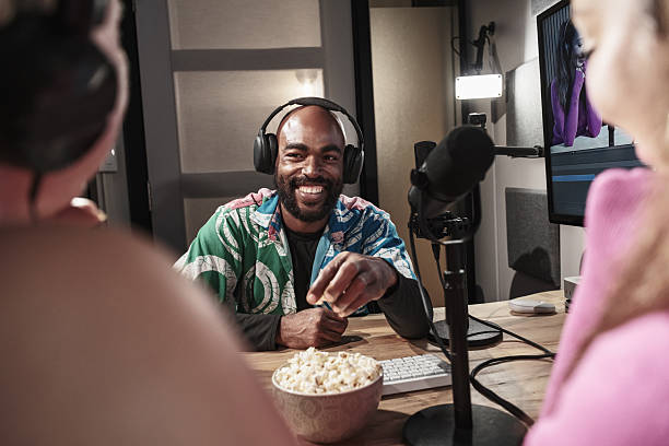 Diverse group of university students broadcasting podcast online. They are dressed in casual clothing. Interior of University podcast studio in Toronto, Canada.