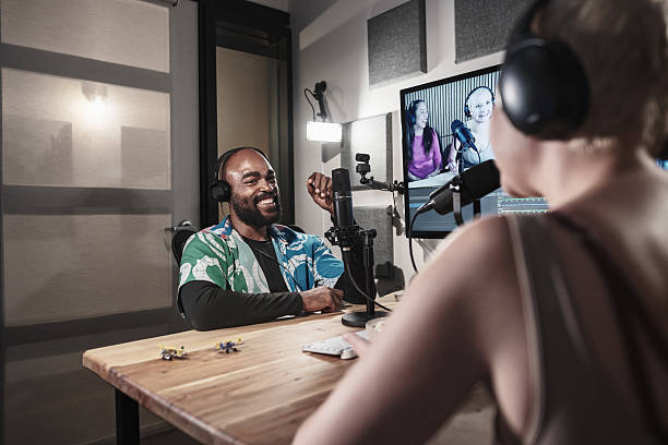 Diverse group of university students broadcasting podcast online. They are dressed in casual clothing. Interior of University podcast studio in Toronto, Canada.