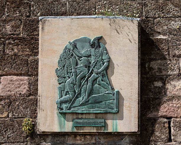 Nottingham, UK - July 28th 2025: Plaque depicting Robin Hood and Little John fighting on a bridge - the plaque is located near the Robin Hood statue outside Nottingham Castle in Nottingham, UK.