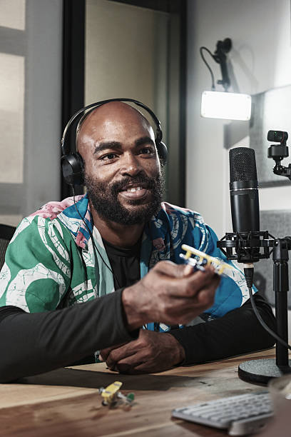 istock Young black man hosting university students podcast online 2243089352