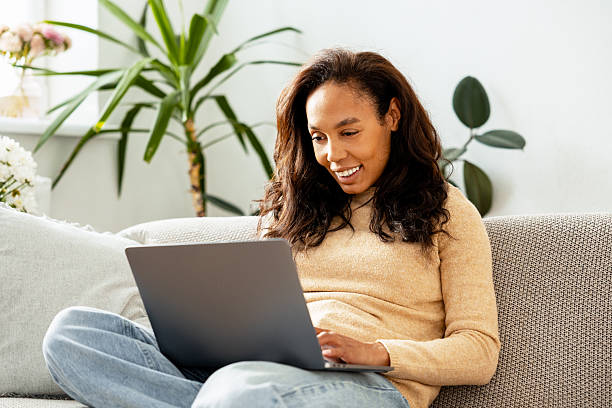 istock Successful smiling African American woman using laptop checking mail, copywriter typing on keyboard 2243091193