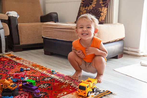 Boy playing with toys showing teeth