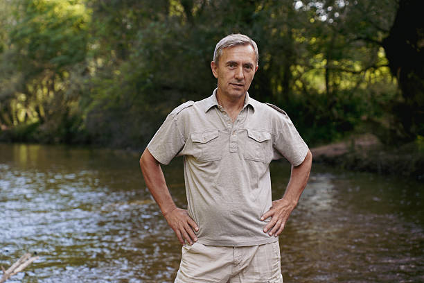 istock Senior man enjoying nature and shallow river on a sunny day 2243094465