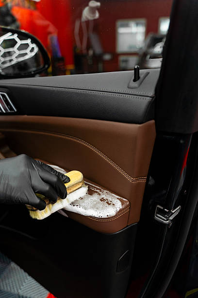 istock Removing dust and dirt from car door panel using brush and detergent for deep clean. Detailing process includes brushing and washing car door panel to remove dust dirt and debris safely. 2243096104