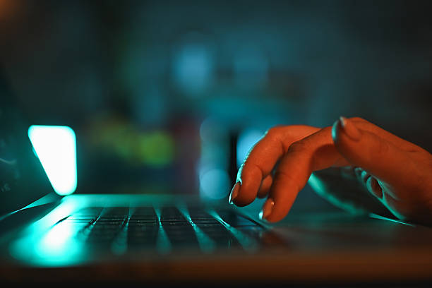 istock Person typing on laptop keyboard at night 2243096691