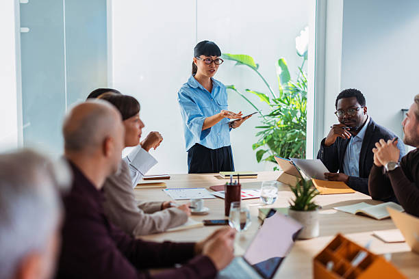 istock Business Meeting With Presenter Leading Discussion In Modern Office Setting 2243098214