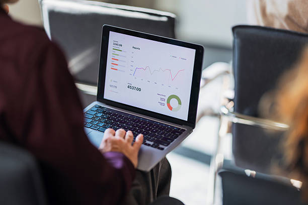 istock Business Professional Analyzing Digital Dashboard On Laptop In Modern Office Setting During Meeting 2243098243