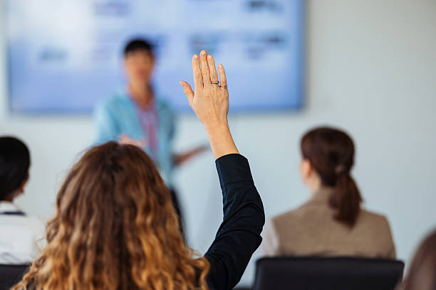 istock Audience Member Raising Hand During Presentation At Seminar In Professional Conference 2243098256