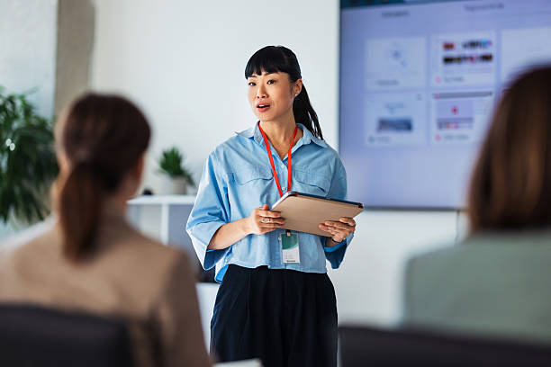 istock Professional Presenter With Tablet Leads Meeting During Team Briefing In Bright Office 2243098260