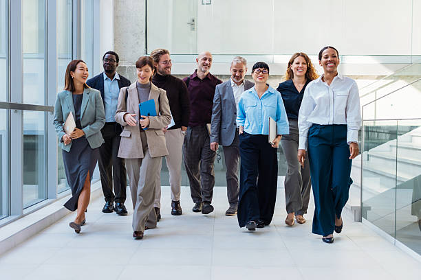 istock Diverse Team Of Professionals Walking Together In A Bright Modern Office Corridor 2243098301