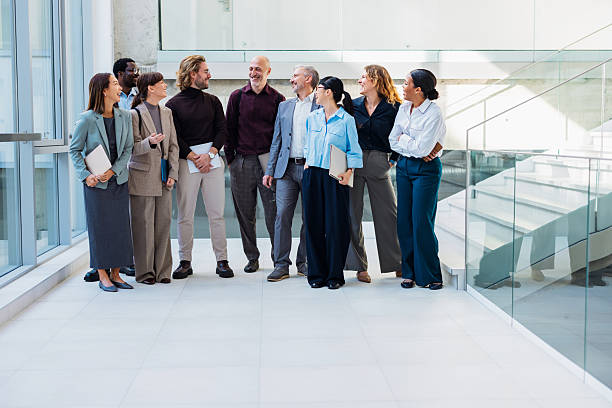 istock Diverse Business Team Group Laughing and Talking in Modern Office Corridor 2243098306