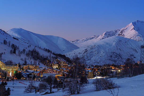 istock Panoramic twilight view of a snow-covered alpine village lights 2243102449
