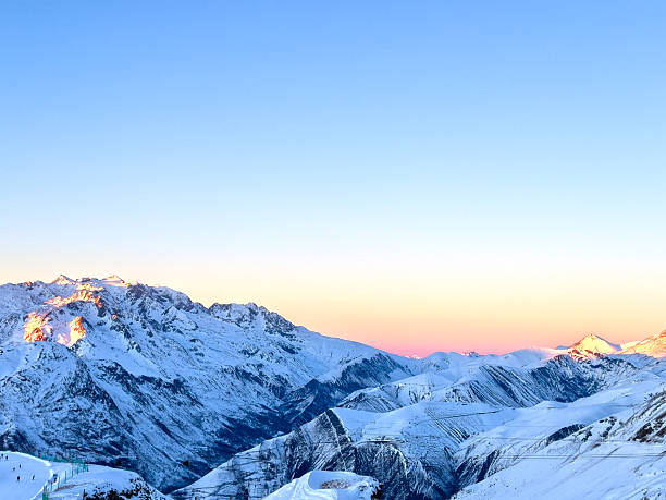 istock A tranquil alpine panorama, with snowy peaks on clear sunset sky 2243102468